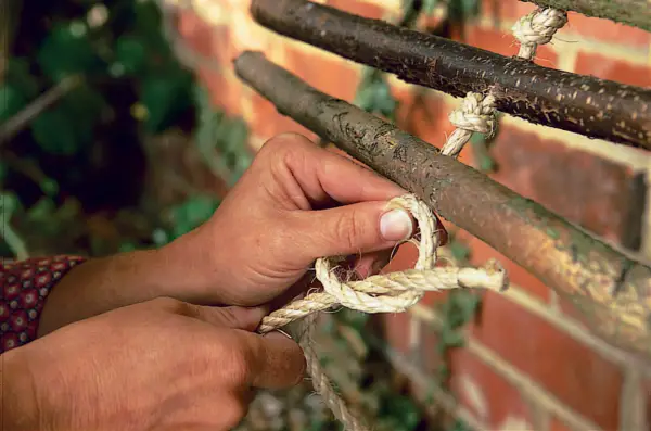 Threading hazel poles onto the rope