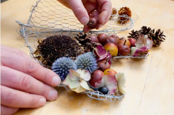 Filling the wire heart with foraged material