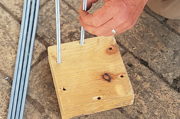 How to make a metal garden obelisk - placing the rods in the timber
