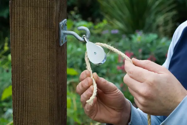 Attach the wall plates and pulleys to a secure support