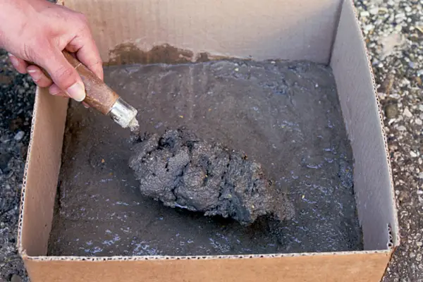 Placing cement in the cardboard box