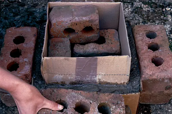 Weighing down the box with bricks