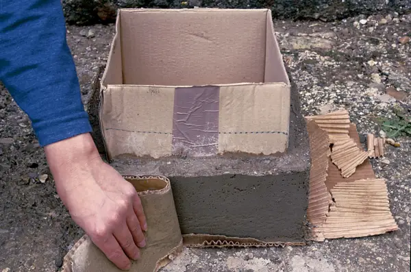 Peeling the cardboard from the box