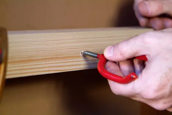 How to make a garden shed tool rack - screwing in the hooks
