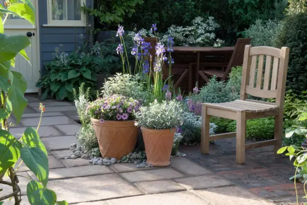 A patio with pots and garden furniture