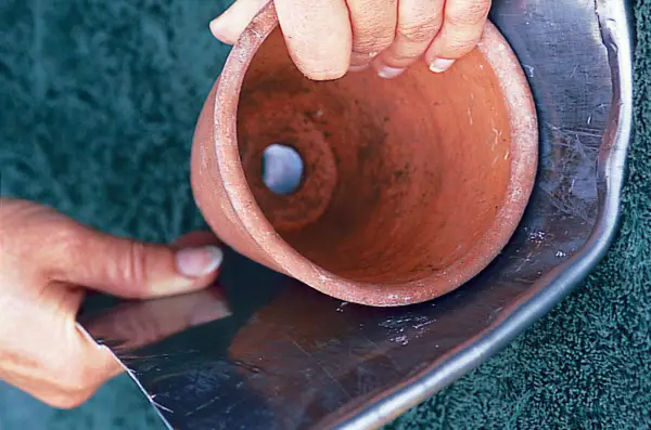 Making a lead planter - wrapping the lead round a pot