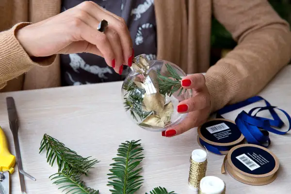 Fill the baubles with greenery from the garden