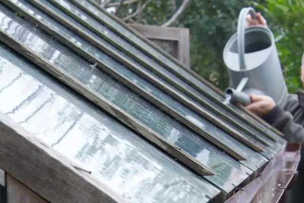 Pouring water on the roof to check the guttering at the moment