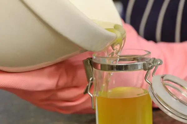 How to make comfrey ointment - pouring the mixture into a container