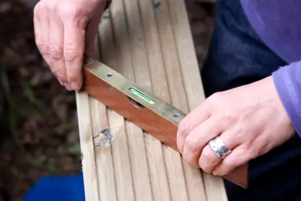How to build a garden pond - using a spirit level to check the sides are level