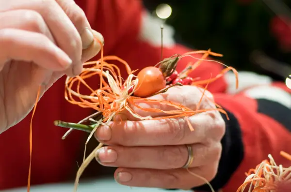 Combining winter berries with raffia