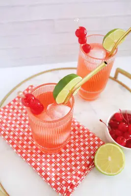 Classic Shirley Temple mocktail with lime wedge and cherry
