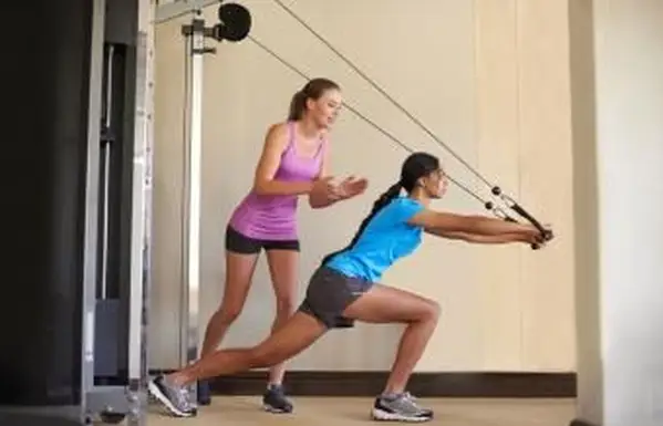 Mulheres usando máquina de cabo e polia