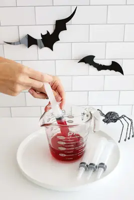 making Halloween jello shots in syringes
