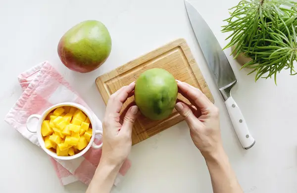 Mango and diced mango on cutting board