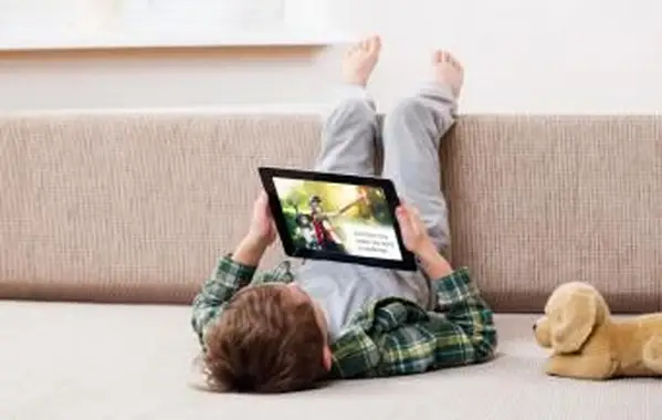 Junge liest auf digitalem Tablet