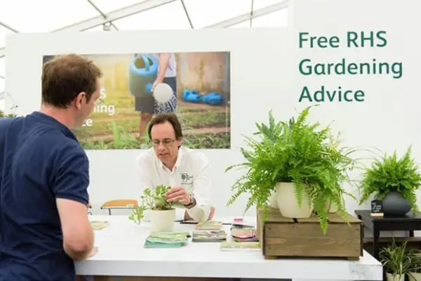 Someone being offered free RHS Gardening Advice by a RHS employee