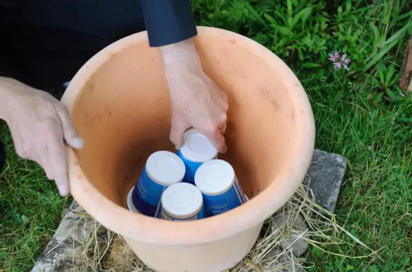 Adding crocks to the bottom of the pot