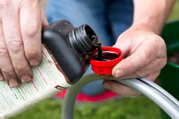 Gardener making a liquid feed for plants
