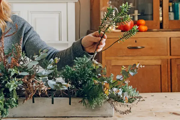 How to make a table decoration for Christmas - adding the flowers and foliage