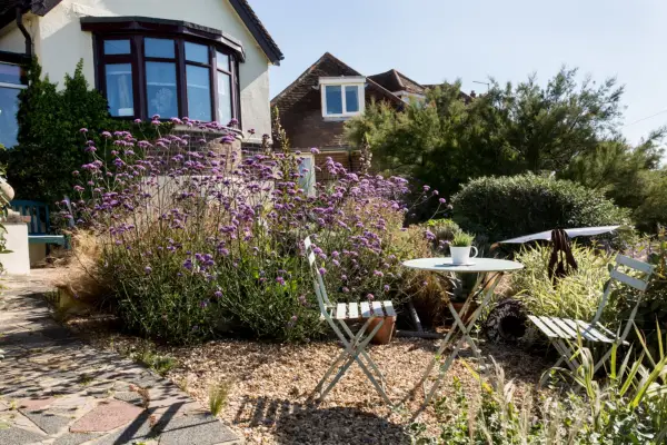 Driftwood: the front garden has a seaside feel with agaves, Verbena bonariensis and grasses growing through the gravel
