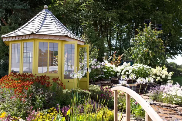 Garden with yellow summer house