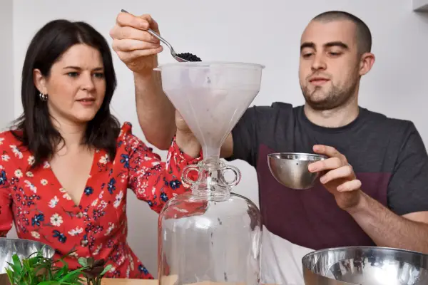 Adding a dessertspoon of crushed charcoal. Will and Madeleine Taylor