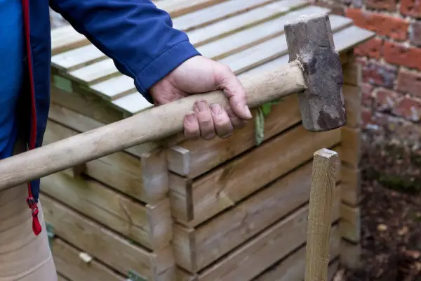 Driving wooden stakes into the ground