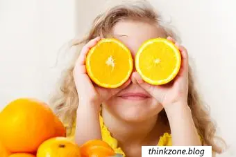 Bambina felice con frutta a casa