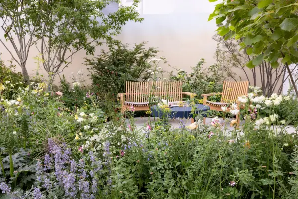 Wooden furniture and relaxed planting complete the cottage garden look. Paul Debois