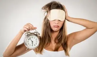 Mulher cansada com relógio e venda