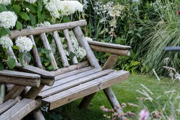 Wooden bench in cottage garden