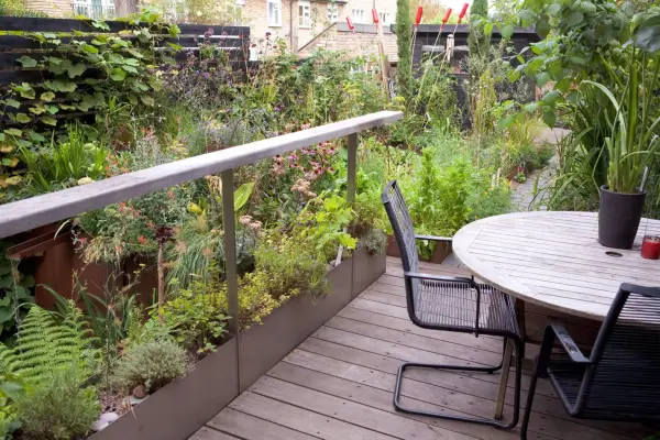 Black garden chair with table in wild garden