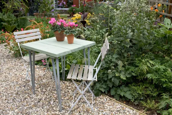 Garden wood and metal bistro set on gravel