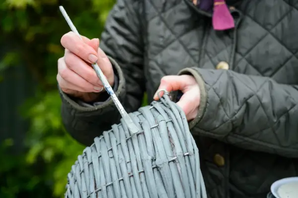 Painting a woven hazel hanging basket