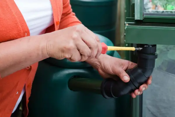 Fitting a downpipe to a greenhouse to save water