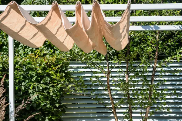 Pergola with retractable shade canopy