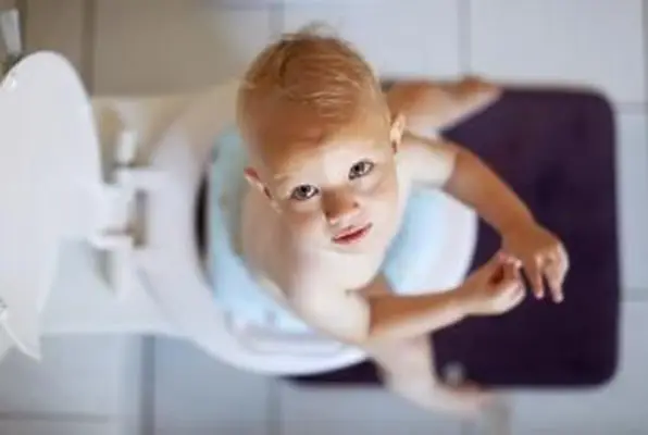 Petit garçon apprenant à utiliser les toilettes