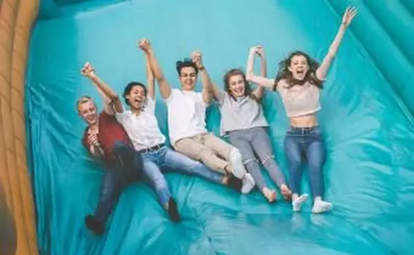 Adolescentes pulando slide