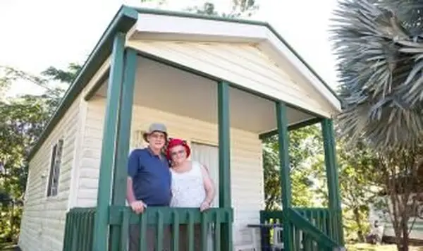 Casal de idosos na frente de sua casa móvel