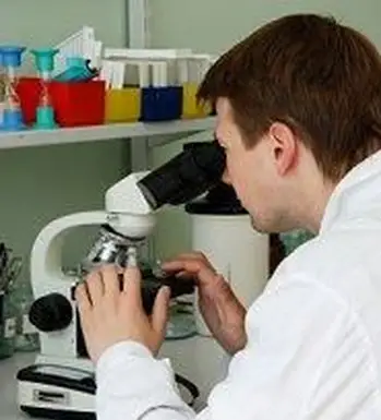 Medico che utilizza un microscopio per diagnosticare una MST